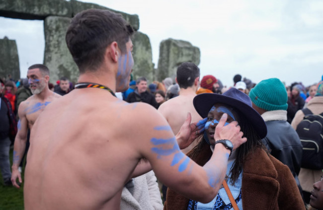 a-person-has-their-face-painted-as-they-take-part-in-the-winter-solstice-celebrations-during-sunrise-at-the-stonehenge-prehistoric-monument-on-salisbury-plain-in-wiltshire-picture-date-saturday-dece