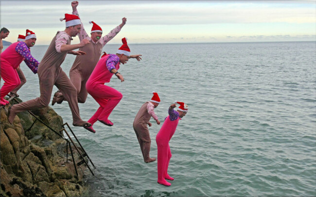 members-of-the-public-braving-the-cold-weather-and-icy-conditions-for-a-dip-in-the-irish-sea-at-the-forty-foot-bathing-spot-in-sandycove-dublin-on-the-annual-christmas-day-swim