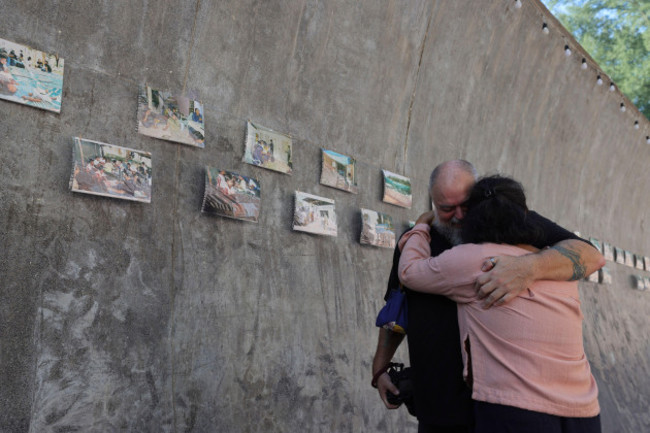 relatives-of-a-victim-of-a-2004-indian-ocean-tsunami-hug-each-other-during-its-20th-anniversary-at-tsunami-memorial-park-at-ban-nam-khem-takuapa-district-of-phang-nga-province-southern-thailand-thu