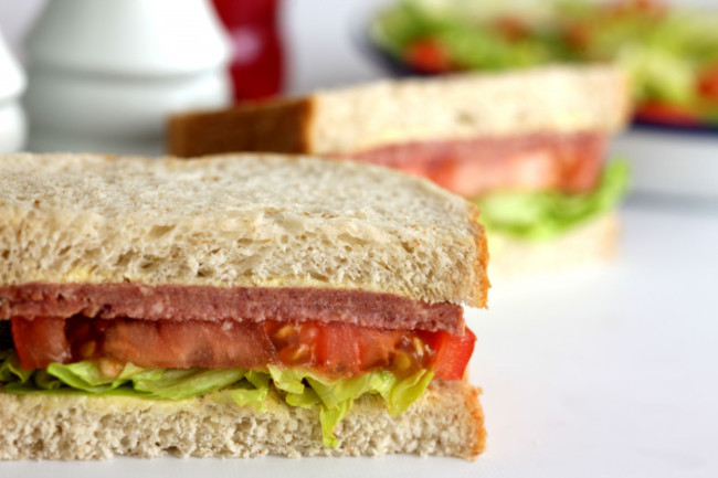 fresh-tasty-corned-beef-sandwich-in-brown-bread-isolated-against-a-white-background-with-no-people-and-a-clipping-path