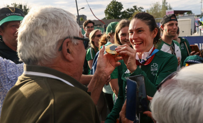 katie-george-dunlevy-displays-the-gold-medal-to-her-father-john