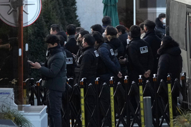 police-officers-arrive-at-the-gate-of-the-presidential-residence-as-supporters-of-impeached-south-korean-president-yoon-suk-yeol-stage-a-rally-to-oppose-a-court-having-issued-a-warrant-to-detain-yoon