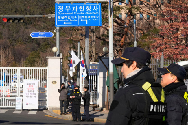 police-officers-stand-guard-as-they-wait-for-the-arrival-of-impeached-south-korean-president-yoon-suk-yeol-near-the-corruption-investigation-office-for-high-ranking-officials-in-gwacheon-south-korea