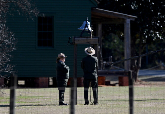 karen-barry-left-and-randy-dillard-the-longest-serving-nps-plains-staffers-ring-the-farm-bell-39-times-as-the-motorcade-with-the-flag-draped-hearse-of-former-president-jimmy-carter-stops-in-front