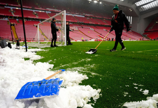 stewards-shovel-snow-to-the-side-of-the-pitch-ahead-of-the-premier-league-match-at-anfield-liverpool-picture-date-sunday-january-5-2025