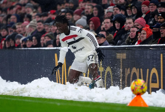 manchester-uniteds-kobbie-mainoo-slides-into-a-bank-of-snow-on-the-touchline-during-the-premier-league-match-at-anfield-liverpool-picture-date-sunday-january-5-2025