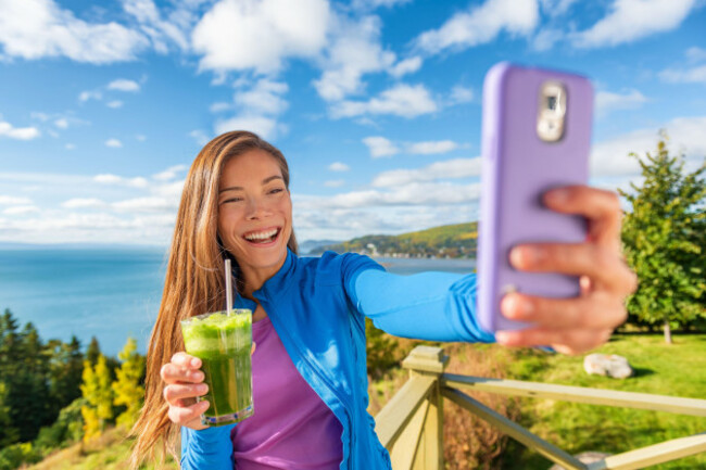 selfie-phone-asian-girl-social-media-influencer-promoting-health-benefits-of-vegan-diet-green-smoothie-drink-healthy-detox-juice-woman-drinking