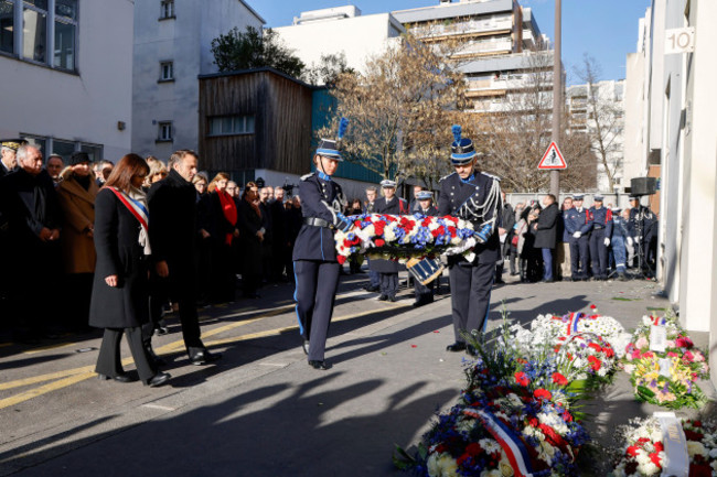 french-president-emmanuel-macron-and-paris-mayor-anne-hidalgo-left-arrive-to-lay-a-wreath-during-a-commemoration-marking-10-years-since-an-islamist-attack-on-the-charlie-hebdo-satirical-newspaper-a