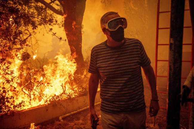 will-adams-watches-as-flames-from-the-palisades-fire-close-in-on-his-property-in-the-pacific-palisades-neighborhood-of-los-angeles-tuesday-jan-7-2025-ap-photoethan-swope