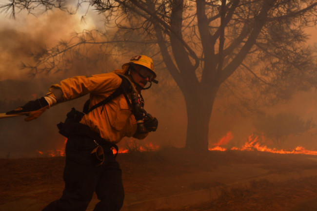 a-firefighter-battles-the-advancing-palisades-fire-in-the-pacific-palisades-neighborhood-of-los-angeles-tuesday-jan-7-2025-ap-photoetienne-laurent