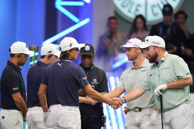 rickie-fowler-of-new-york-golf-club-third-left-shakes-hands-with-shane-lowry-of-the-bay-golf-club-as-the-teams-prepare-for-the-start-of-the-inaugural-match-of-the-tmrw-golf-league-tuesday-jan-7