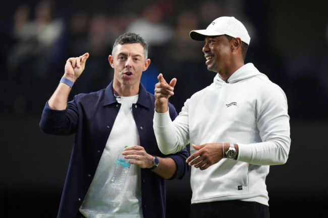 rory-mcilroy-and-tiger-woods-stand-on-the-green-as-they-watch-new-york-golf-club-and-the-bay-golf-club-warmup-for-the-inaugural-match-of-the-tmrw-golf-league-tuesday-jan-7-2025-in-palm-beach-gard