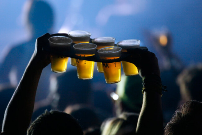 ambiance-during-live-rock-concert-and-man-bringing-pints-of-beer-in-plastic-cups-to-friends-among-spectators-crowd-belgium