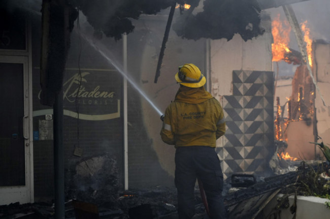 los-angeles-county-fire-dept-fire-fighters-battle-flames-at-the-altadena-florist-during-the-eaton-fire-wednesday-jan-8-2025-in-the-altadena-section-of-pasadena-calif