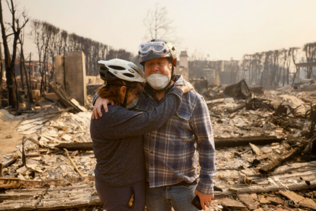 claudio-and-kathleen-boltiansky-embrace-in-their-fire-ravaged-neighborhood-after-the-palisades-fire-swept-through-in-the-pacific-palisades-neighborhood-of-los-angeles-wednesday-jan-8-2025-ap-pho