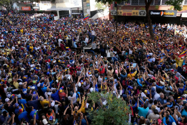 supporters-of-venezuelan-opposition-leader-maria-corina-machado-surround-the-truck-she-waves-from-during-a-protest-against-venezuelan-president-nicolas-maduro-the-day-before-his-inauguration-for-a-thi