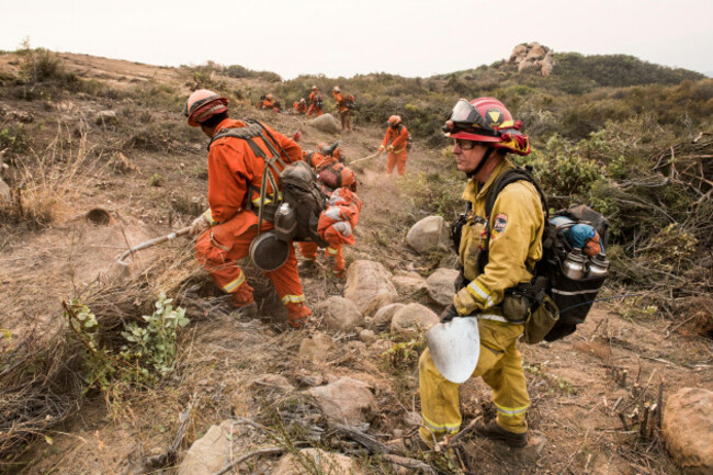 california-department-of-corrections-inmate-fire-fighters-clear-a-fire-line-near-santa-barbara-california-dec-11-2017-the-inmates-were-brought-in-to-help-fight-the-thomas-fire-the-fire-started-on