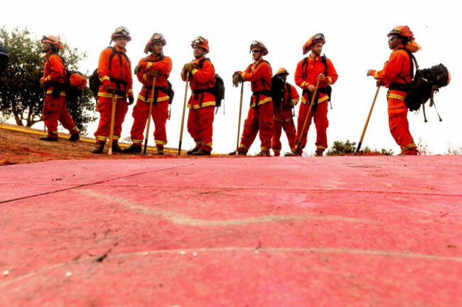 file-in-this-aug-17-2020-photo-inmate-firefighters-notable-by-their-bright-orange-fire-gear-compared-to-the-yellow-worn-by-professional-firefighters-prepare-to-take-on-the-river-fire-in-sali