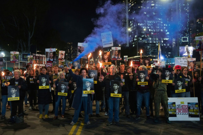 demonstrators-hold-torches-during-a-protest-calling-for-the-immediate-release-of-the-hostages-held-in-the-gaza-strip-by-the-hamas-militant-group-in-tel-aviv-israel-on-monday-jan-13-2025-ap-phot