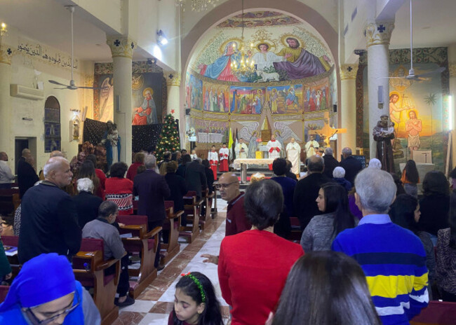 palestinian-christians-participate-in-the-christmas-mass-at-the-church-of-the-holy-family-in-gaza-city-palestinian-christians-participate-in-the-christmas-mass-at-the-church-of-the-holy-family-in-gaz