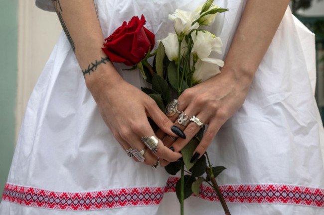 moscow-russia-15th-of-august-2020-women-hold-flowers-as-people-some-of-them-ethnic-belarusians-gather-for-a-rally-against-the-results-of-the-belarusian-presidential-election-in-front-of-belarusia