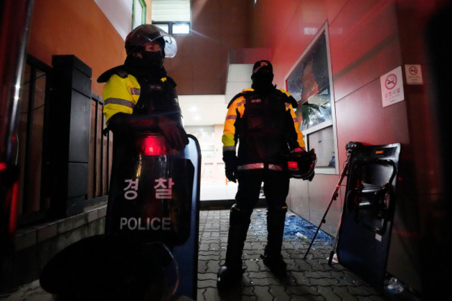 police-officers-stand-at-the-seoul-western-district-court-after-supporters-of-impeached-south-korean-president-yoon-suk-yeol-broke-into-the-court-in-seoul-south-korea-sunday-jan-19-2025-ap-phot