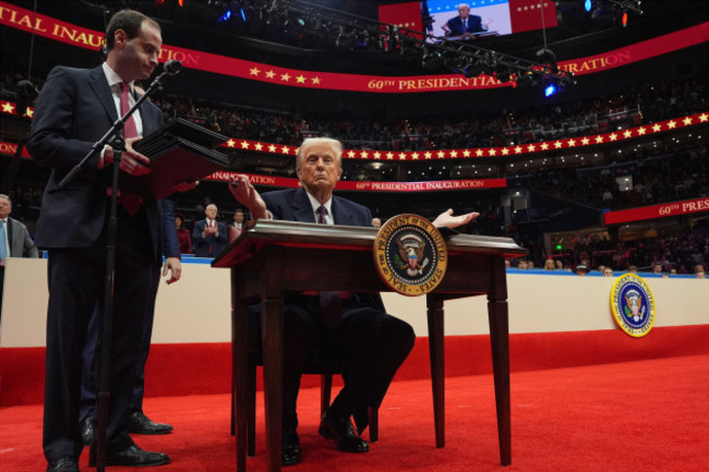 president-donald-trump-finishes-signing-executive-orders-as-he-attends-an-indoor-presidential-inauguration-parade-event-at-capital-one-arena-monday-jan-20-2025-in-washington-ap-photoevan-vucci