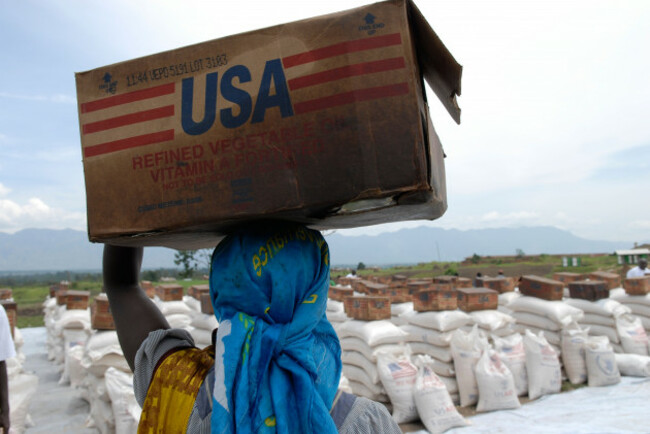 man-carrying-box-of-refined-vegetable-oil-donated-by-usaid-at-a-world-food-programme-distribution-point-in-north-kivu-dr-congo-image-shot-2007-exact-date-unknown