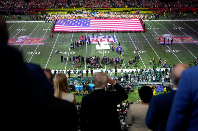 president-donald-trump-in-foreground-center-salutes-as-jon-batiste-performs-the-national-anthem-at-the-nfl-super-bowl-59-football-game-between-the-philadelphia-eagles-and-the-kansas-city-chiefs-sun