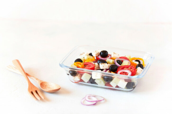 lunch-box-with-greek-salad-on-white-background