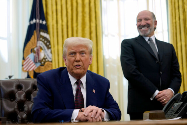 president-donald-trump-speaks-to-reporters-as-commerce-secretary-nominee-howard-lutnick-listens-after-trump-signed-an-executive-order-in-the-oval-office-of-the-white-house-thursday-feb-13-2025-in