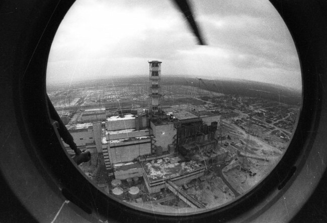 in-this-1986-photo-a-chimney-and-the-sarcophagus-under-construction-over-the-4th-destroyed-reactor-at-the-chernobyl-nuclear-power-plant-is-seen-through-a-helicopter-window-on-may-12-1986-more-than