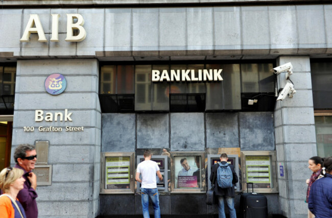 people-pass-the-front-of-the-aib-bank-in-the-grafton-street-in-dublin-the-aib-bank-is-one-of-the-greatest-banks-in-ireland