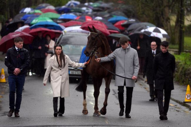 the-hearse-carrying-the-coffin-of-michael-osullivan-is-lead-by-a-horse-away-from-the-grounds-following-the-funeral-at-st-john-the-baptist-church-glantane-jockey-michael-osullivan-died-as-a-result