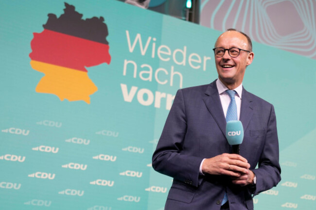 friedrich-merz-the-candidate-of-the-mainstream-conservative-christian-democratic-union-party-smiles-while-addressing-supporters-at-the-party-headquarters-in-berlin-germany-sunday-feb-23-2025-a