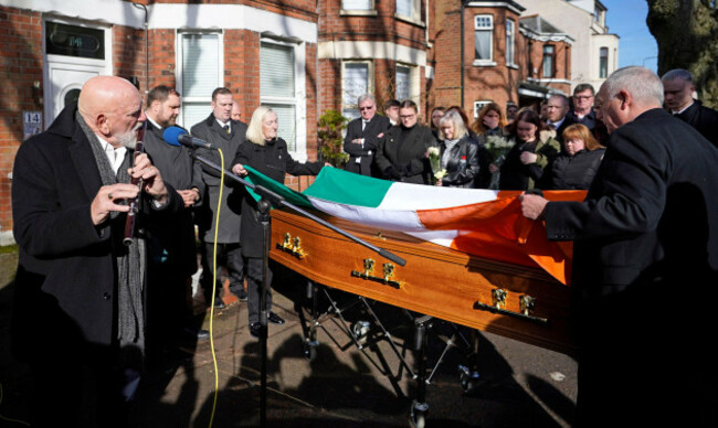 matt-malloy-of-the-chieftains-plays-the-flute-as-the-flag-is-placed-on-the-coffin-of-brendan-bik-mcfarlane-as-it-leaves-his-family-home-on-cliftonville-road-belfast-the-former-senior-ira-man-kno