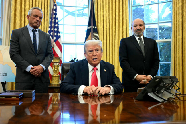 president-donald-trump-speaks-to-reporters-before-signing-an-executive-order-as-health-and-human-services-secretary-robert-f-kennedy-jr-left-and-commerce-secretary-howard-lutnick-listen-in-the-ova