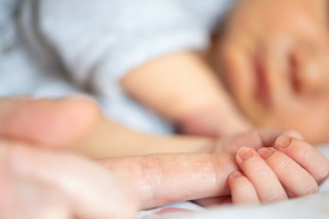 close-up-view-of-newborn-baby-boy-holding-finger-of-parent