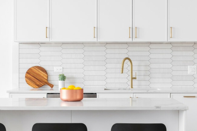 akitchendetailwithwhitecabinetsapickettiledbacksplash