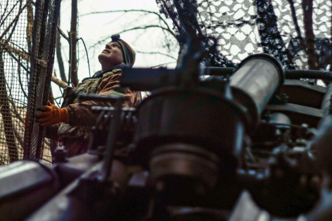 a-ukrainian-soldier-looks-at-the-sky-searching-for-russian-fpv-drones-as-he-gets-ready-to-fire-a-m777-howitzer-towards-russian-positions-at-the-frontline-near-donetsk-ukraine-monday-march-3-2025