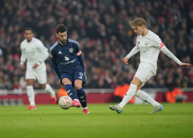 arsenals-martin-odegaard-right-challenges-for-the-ball-with-manchester-uniteds-bruno-fernandes-during-the-english-fa-cup-soccer-match-between-arsenal-and-manchester-united-at-the-emirates-stadium