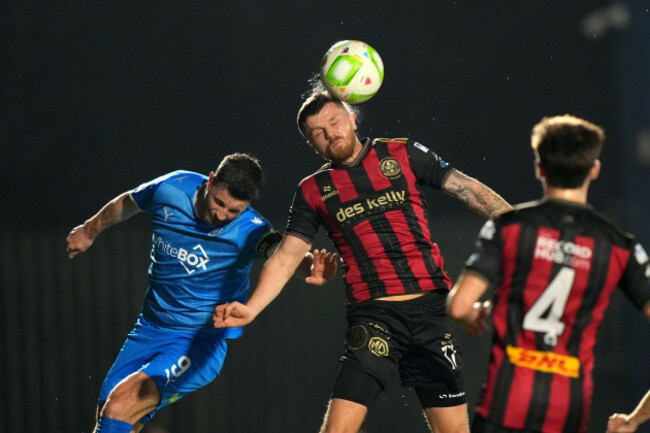 adam-mcdonnell-heads-away-the-ball