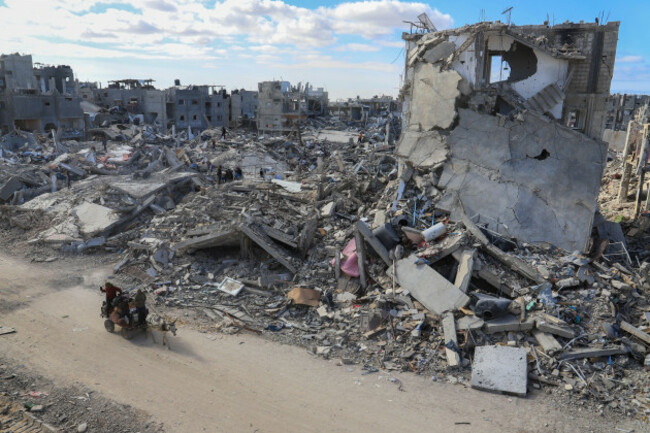 palestinians-ride-in-a-horse-drawn-cart-along-a-street-surrounded-rubble-left-by-the-israeli-air-and-ground-offensive-against-hamas-in-rafah-located-in-the-southern-gaza-strip-on-monday-january-20