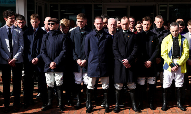 jockeys-applaud-during-a-minutes-applause-for-michael-osullivan-prior-to-the-start-of-the-cheltenham-festival