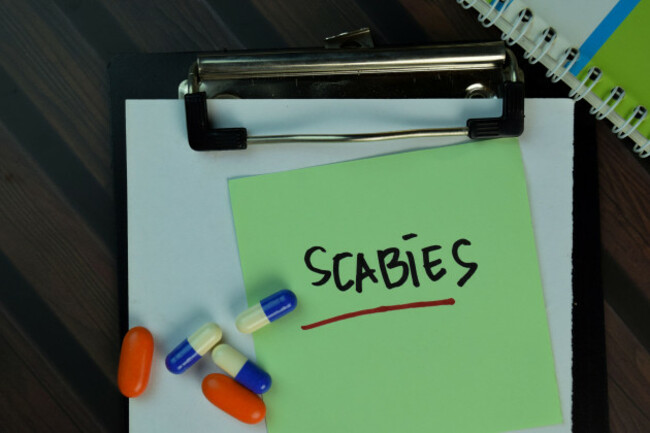 scabies-write-on-sticky-notes-isolated-on-wooden-table-medical-or-healthcare-concept