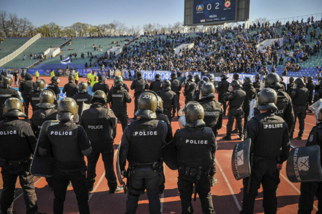 riot-police-stands-between-fans-and-players-after-levski-sofia-fans-invaded-the-pitch-angry-of-they-players-during-bulgarian-football-derby-between-levski-sofia-and-cska-sofia-in-sofia-bulgaria-26-a