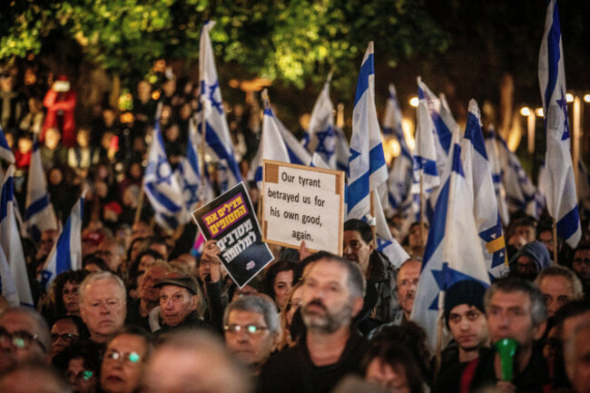 israeli-protesters-wave-their-national-flag-and-hold-up-signs-during-a-demonstration-in-tel-aviv-saturday-march-22-2025-thousands-demonstrated-in-tel-aviv-and-other-israeli-population-centers-on-sat