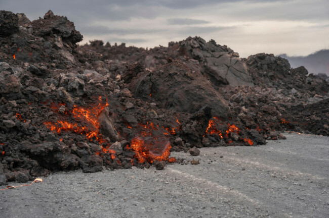 the-lava-flow-from-an-active-volcano-spills-on-the-road-near-grindavik-iceland-saturday-june-8-2024-ap-photomarco-di-marco