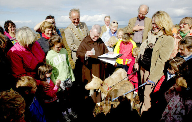 father-brian-mckay-of-the-carmelite-church-on-whitefriar-street-pours-holy-water-on-the-head-of-one-of-three-goats-during-a-blessing-ceremony-on-howth-head-in-dublin-as-three-female-goats-were-releas