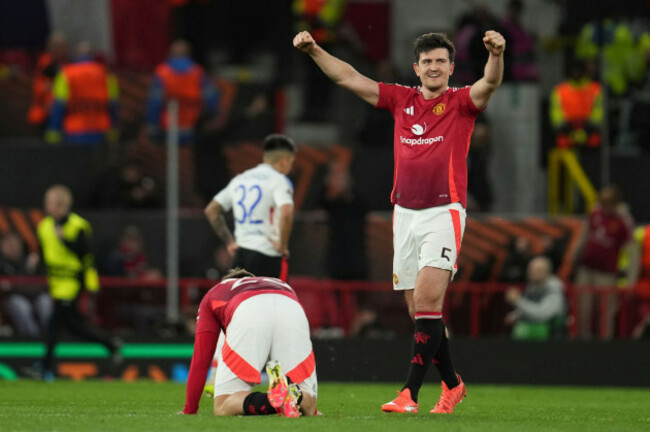manchester-uniteds-harry-maguire-celebrates-besides-luke-shaw-after-the-europa-league-quarter-final-second-leg-soccer-match-between-manchester-united-and-olympique-lyon-in-manchester-britain-thursd